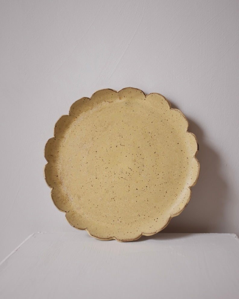 Large scalloped plate — speckled yellow